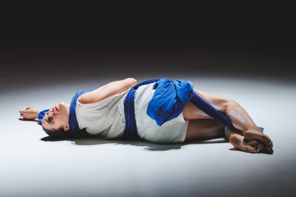 La danseuse Lea Anderson est allongée dans un bain de lumière, création lumière de Jérôme Baudouin, créateur lumière en danse, théâtre et spectacle vivant